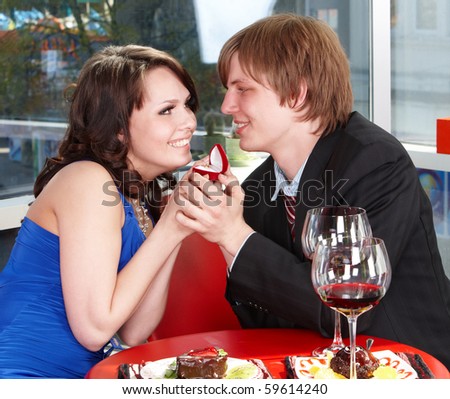 Couple on date in restaurant drink wine.