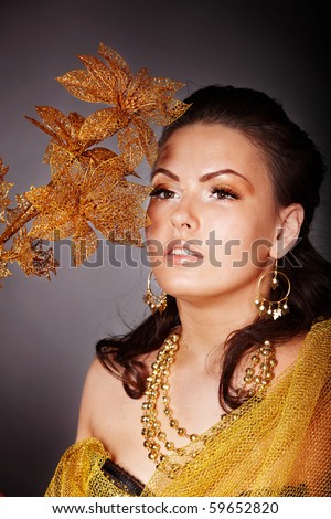 Beautiful young woman with flower. Portrait.