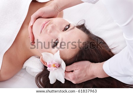 Beautiful young woman in spa. Facial massage.