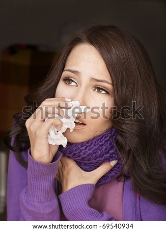 Young woman with handkerchief having  cold. Isolated.