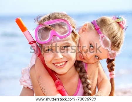 Children playing on  beach. Snorkeling.