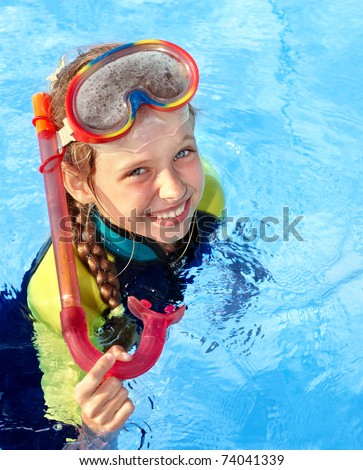 Child in swimming pool learning snorkeling. Sport.