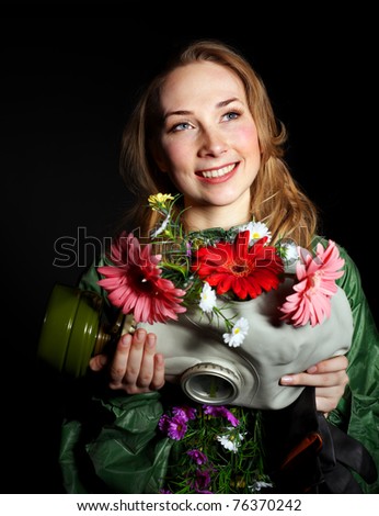 Female hands holding  gas mask with flowers .