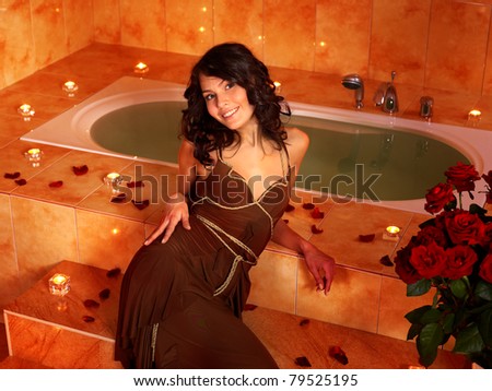 Woman sitting on edge of sauna.