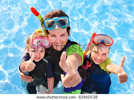 Children with mother  in swimming pool learning snorkeling.