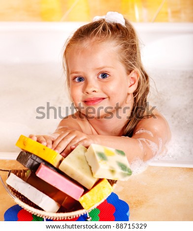 Child washing in bubble bath .