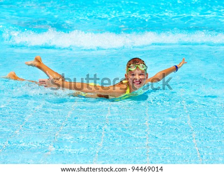 Child in swimming pool. Water sport.