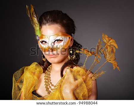 Beautiful young woman  in carnival costume with gold mask.