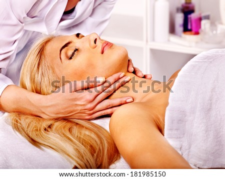Blond woman getting head massage at spa.Woman getting  facial massage .