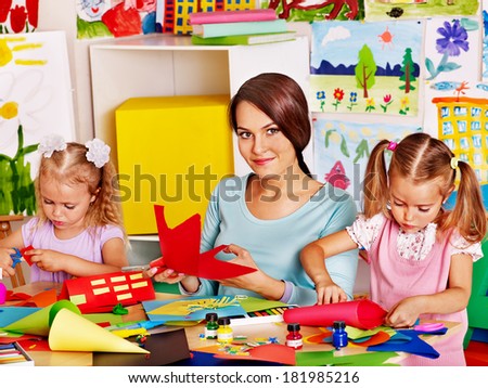 Children  cutting out scissors paper in preschool.
