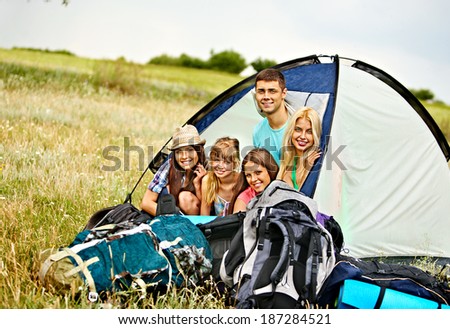 Group people with backpack in tent summer outdoor.