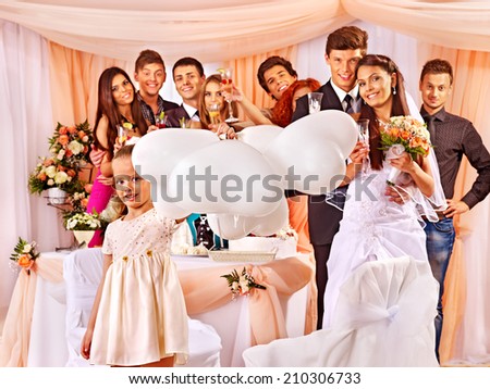 Wedding group people with child in banquet hall.