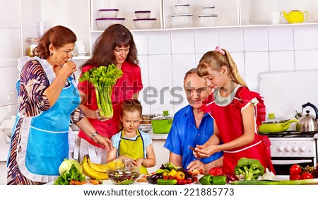 Happy family with child cooking at kitchen. Grandfather and grandmother.