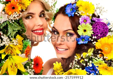 Woman with hairstyle and flower.Portrait of two girl.