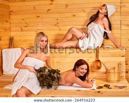 Group women relaxing in sauna.