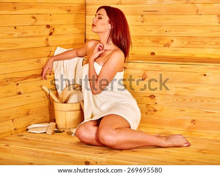 Young woman relaxing in sauna. Healthy lifestyle.