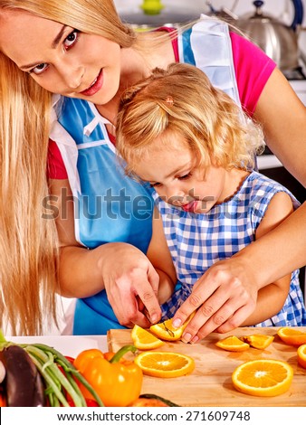 Mother and daughter prepare at kitchen. Interior.