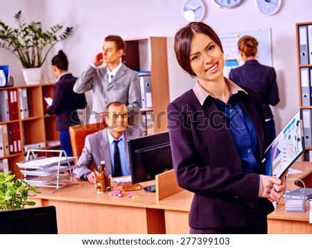 Happy group business people in office. Woman in foreground