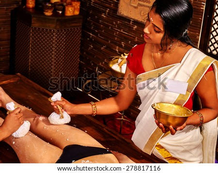 Young woman having indian feet Ayurveda spa massage.