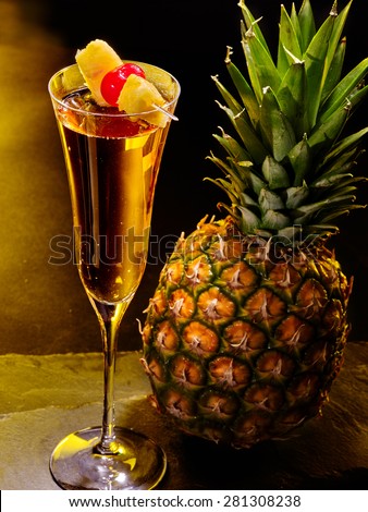 Champagne  cocktail with cherry and whole pineapple with leaves . Cocktail card 59.