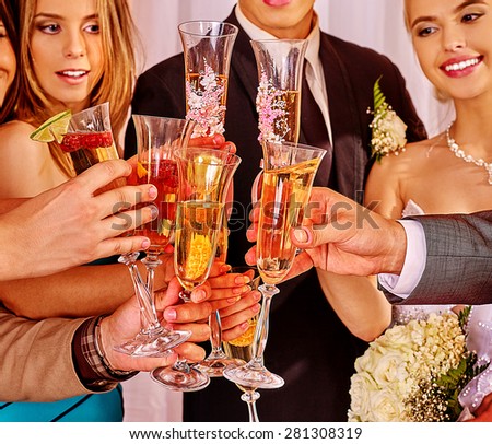 Group people at wedding table drinking champagne.