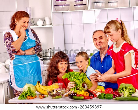 Happy very big family with kids cooking at kitchen. Grandfather and grandmother.