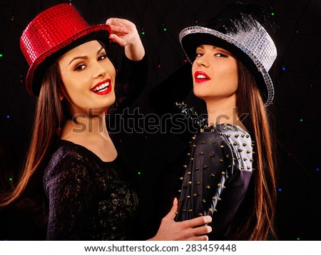 Happy lesbians women in disco hat dancing on party