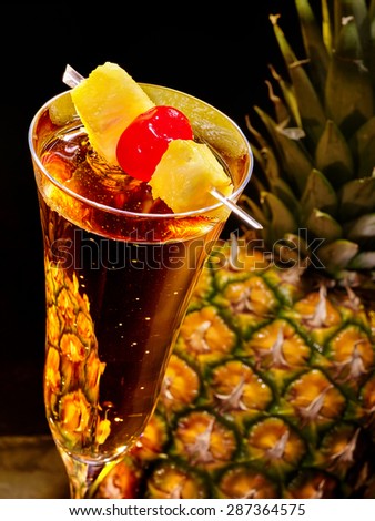 Champagne  cocktail with cherry and whole pineapple with leaves . Cocktail card 69