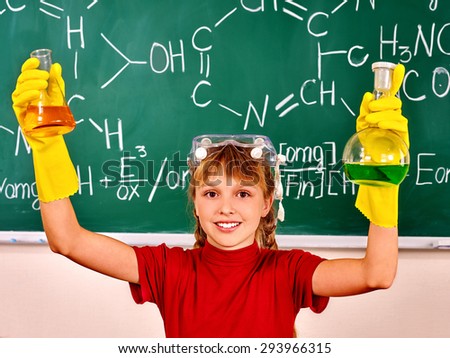 HYappy teen holding flask in chemistry class.