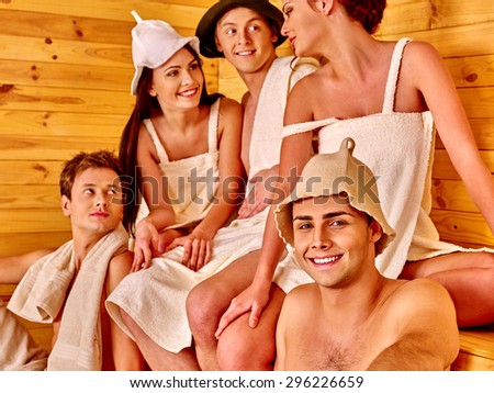 Group people of five in  hat  relaxing at sauna. Men and women.