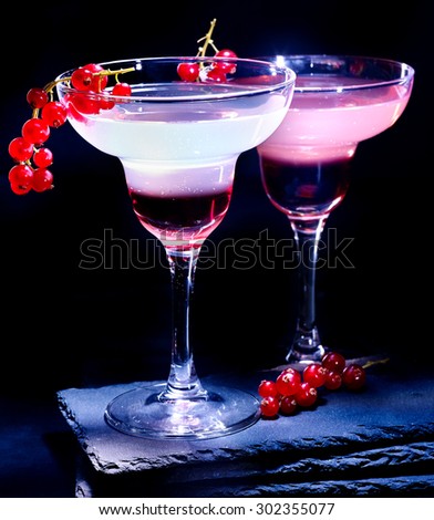 Group pomegranate cocktail decoration red currant  branch  on black background. Cocktail card 77.