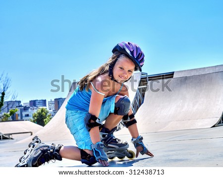 Girl riding on roller skates in skatepark.