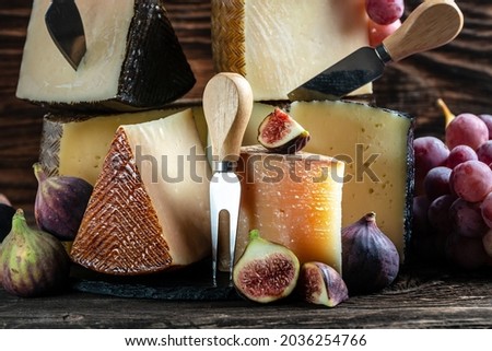 Petit Basque, French cheese, Cheese board of various types of soft and hard cheese. spanish manchego cheese with grapes and figs,