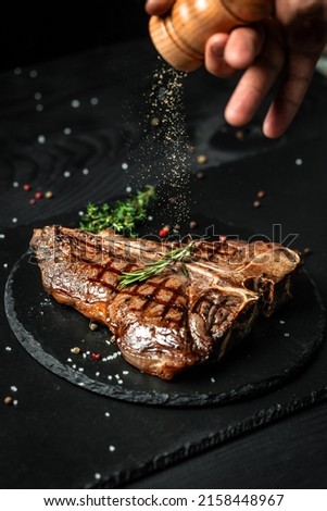 Chef hands cooking meat steak and adding seasoning in a freeze motion. Fresh raw Prime Black Angus beef rump steak. banner, menu recipe. ストックフォト © 