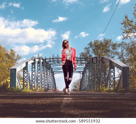 A beautiful woman stand in front of an old bridge in Gyor, Hungary. The lights are smooth, and the focus is on the girl. Stock fotó © 