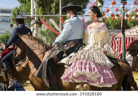 SEVILLE, SPAIN-MAY 8: People mounted on horse on fair of Seville on May 8, 2014 in Seville