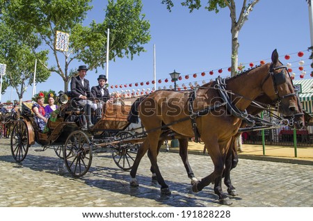 SEVILLE, SPAIN-MAY 8: People mounted on a carriage horse in fair Seville on May 8, 2014 in Seville