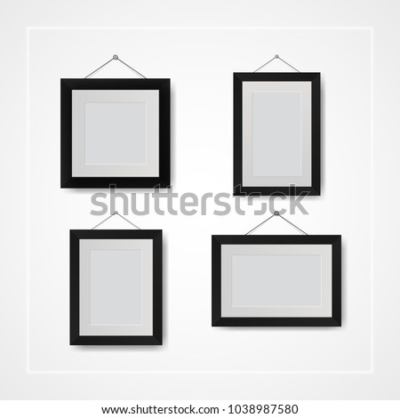 Multiple many small picture and photo frames on white wall