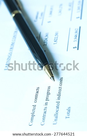 Pen with financial statement background