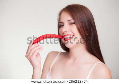 beautiful woman eating chili pepper smile