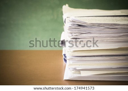 stack of paper on blackboard