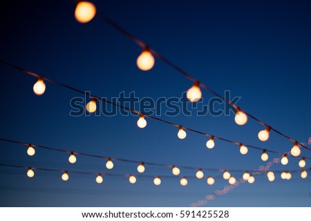 Similar – Image, Stock Photo Lights hang overhead on a clear summer evening