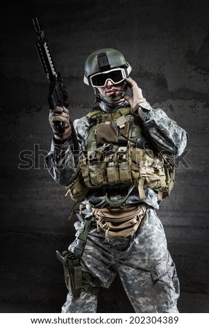 American Soldier wearing a mask and talking via radio