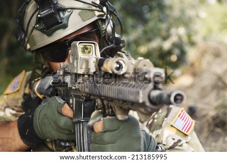 american soldier pointing hi rifle during the military operation