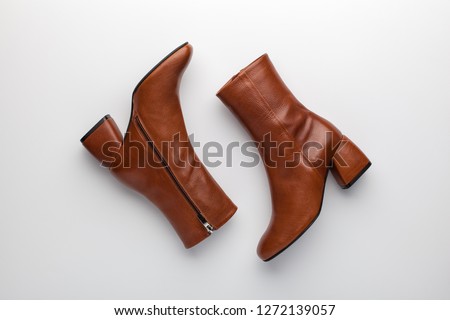 Similar – Image, Stock Photo Woman in brown boots standing on a wooden floor holding a dried artichoke flower in her hand