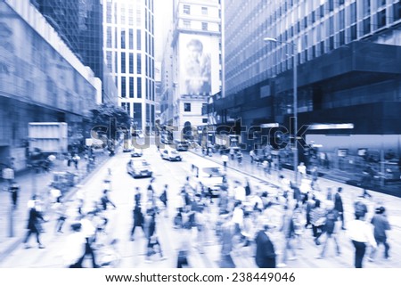 Streets of Hong Kong City. People cross the road at a pedestrian crossing.