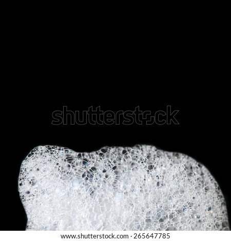 Abstract background of soap foam, suds, shower. Black background. (soft focus)
