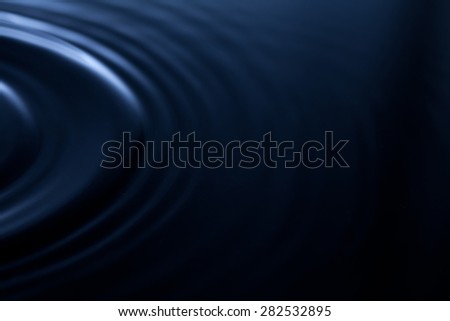 Abstract liquid waves. Dark blue background. Reflections in water. Ripple. plastic, rubber effect. soft focus