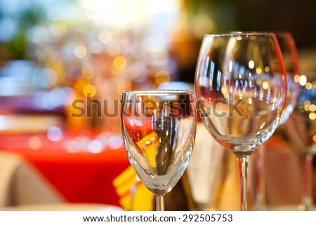 Empty wine glasses, closeup. Bright blurred and soft restaurant, cafe interior background. evening time. soft focus, copy space
