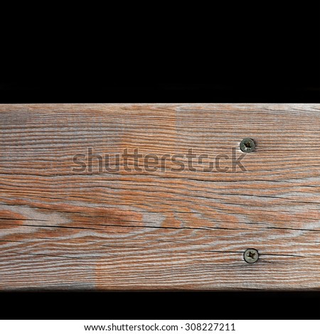 Natural wooden brown floor pattern,  table texture with nail-heads. Aged wood frame, black background. macro view.